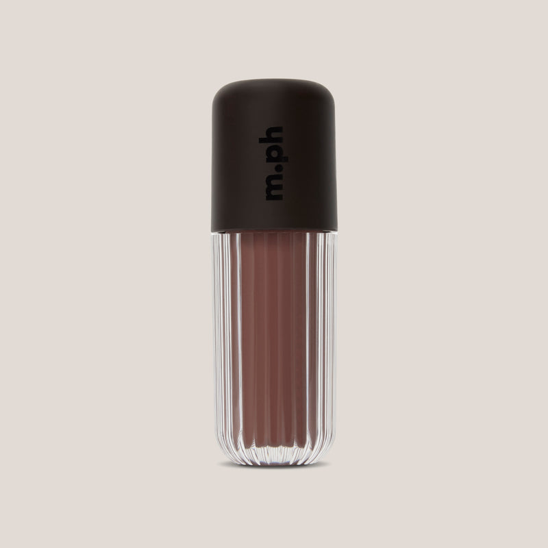 A single lip gloss bottle from the brand m.ph, featuring a ribbed clear glass body showing a dusty rose-brown gloss and a matte black cap with the brand name printed vertically.