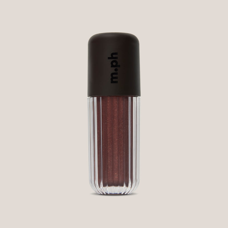 A single lip gloss bottle from the brand m.ph, featuring a ribbed clear lower body showing a shimmering deep berry-brown gloss, topped with a matte black cap.