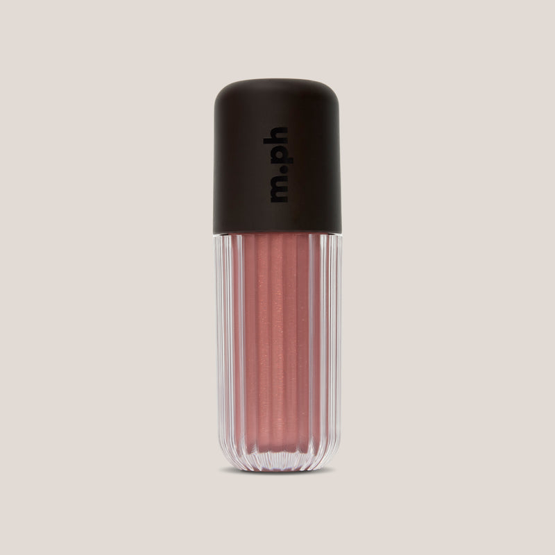 A ribbed clear cosmetic tube containing a shimmering dusty rose pink liquid, topped with a matte black cap featuring the vertical 'm.ph' logo, set against a solid light beige background.