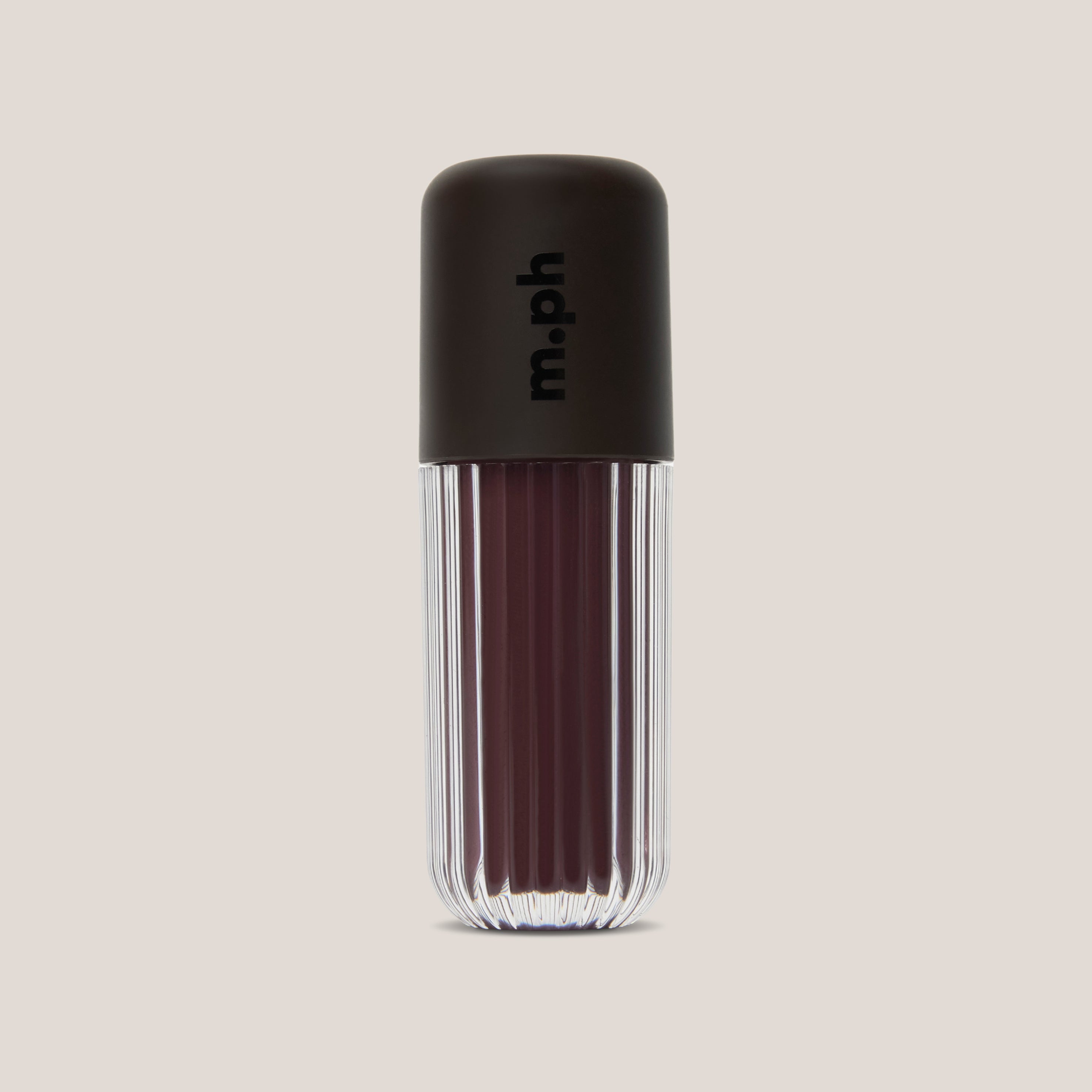 A single lip gloss bottle from the brand m.ph, featuring a dark brown ribbed cap with the brand name printed vertically, and a clear ribbed lower section showing a deep berry-brown gloss inside, set against a solid light beige background.