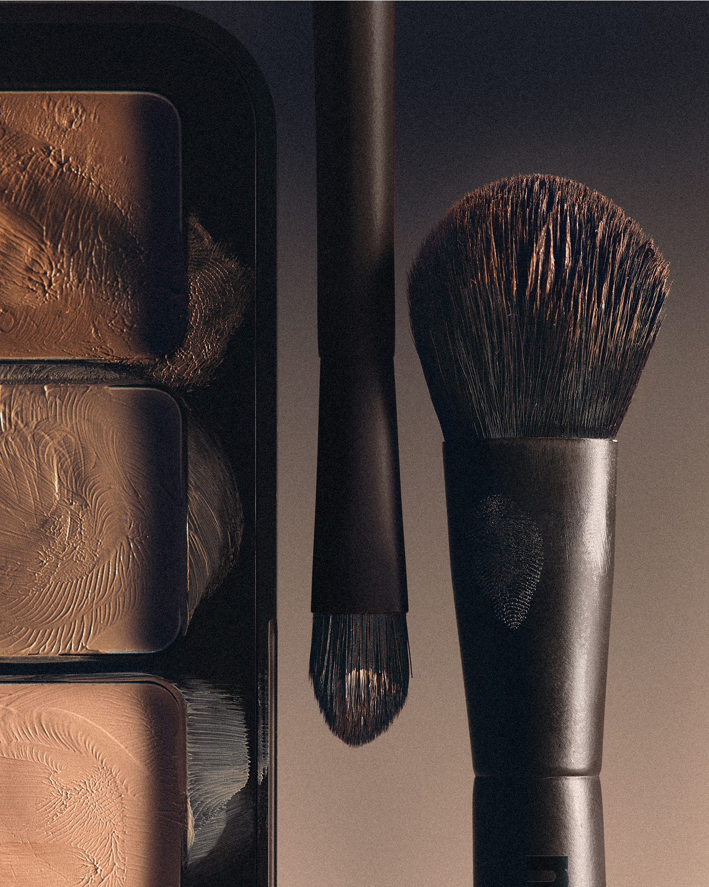 Makeup brushes with a focus on texture and detail against a dark background