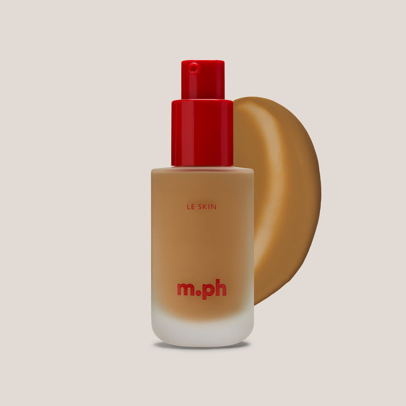m.ph Le Skin full coverage foundation bottle with red pump cap and warm amber swatch