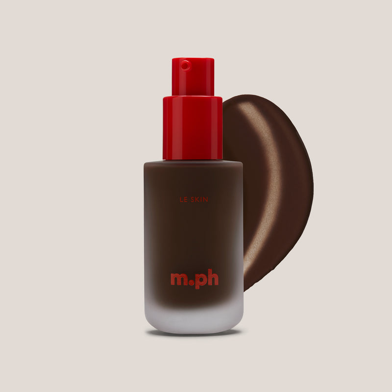 m.ph Le Skin dark toned hydrating foundation bottle with red pump cap and deep umber swatch