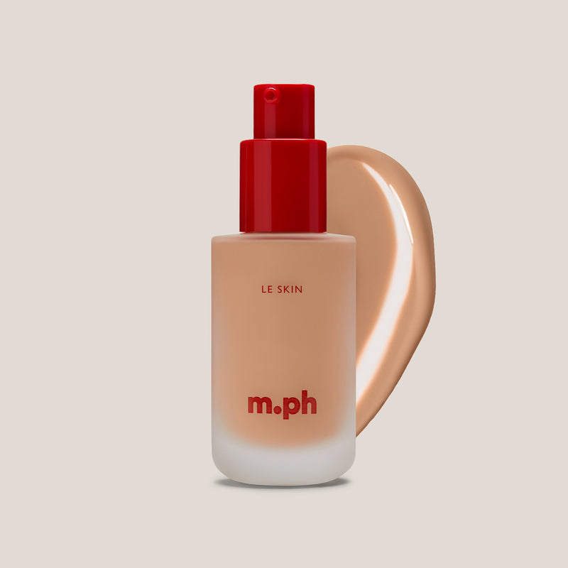 M.PH Le Skin cool beige long lasting makeup in shade 90 with a smooth, hydrating swatch behind the frosted glass bottle.