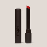 Red lipstick with black package on a beige background