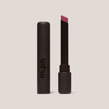 Lipstick with black casing and visible brand 'm.ph' on a beige background