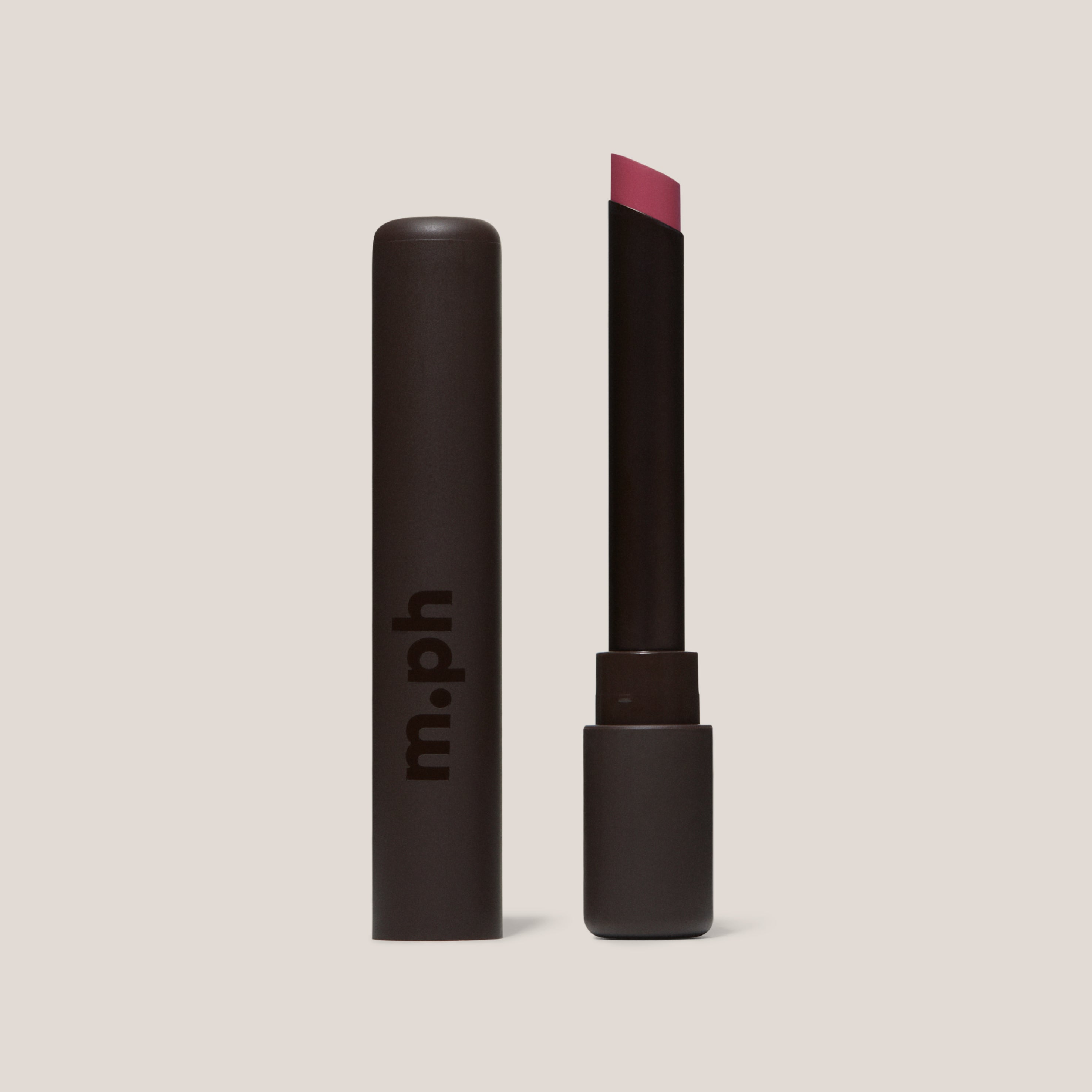 Lipstick with black casing and visible brand 'm.ph' on a beige background