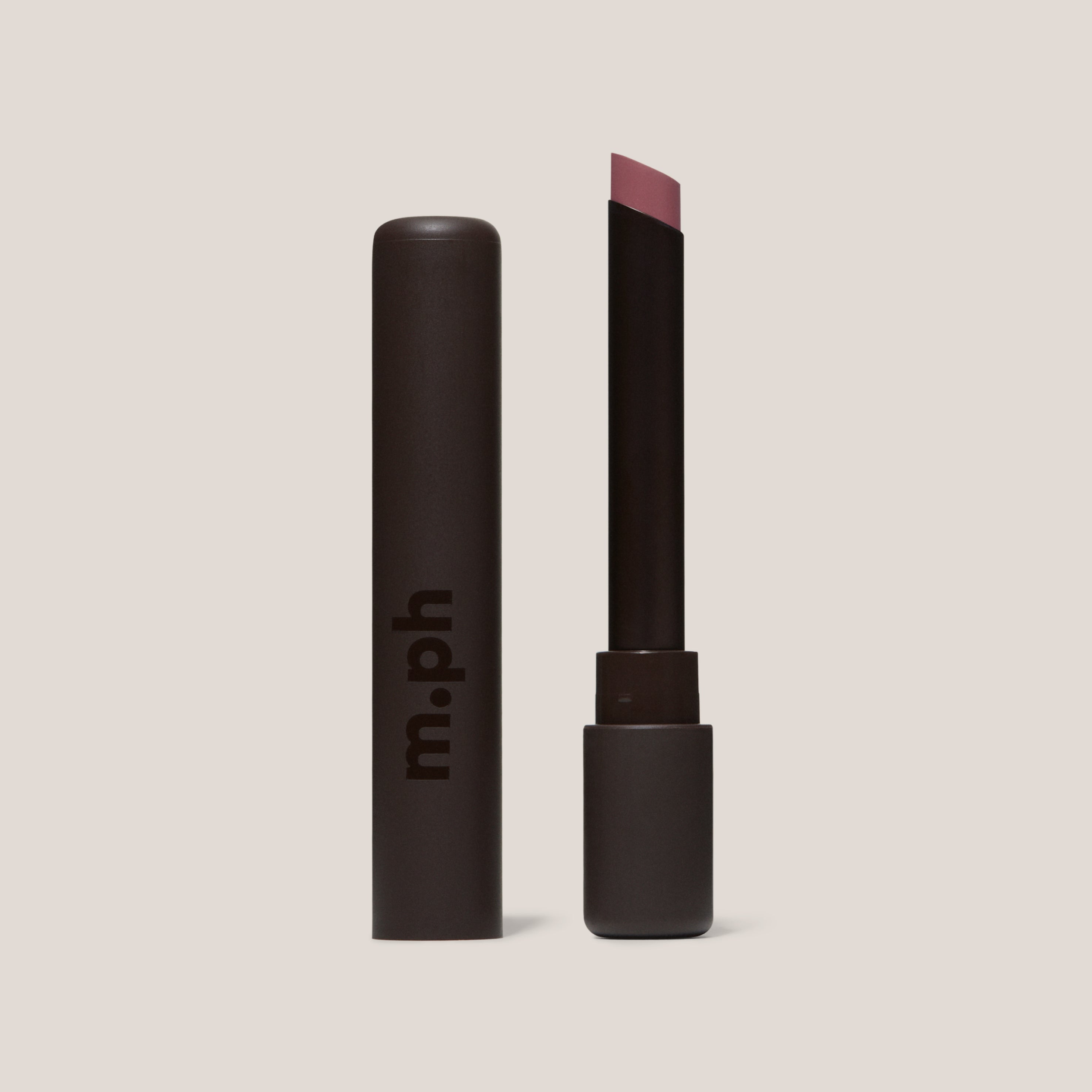 Pink lipstick with open cap on a beige background