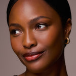 Close-up of a woman with a neutral background
