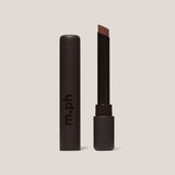 Lipstick with brown shade and 'm.ph' branding on a beige background