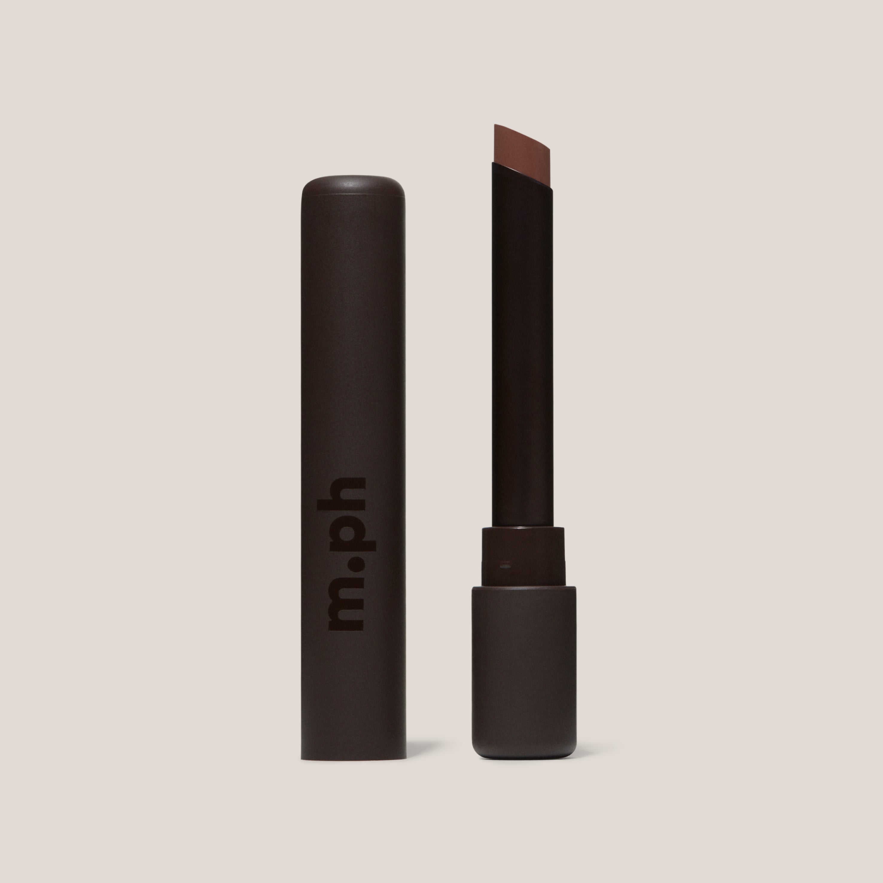 Lipstick with brown shade and 'm.ph' branding on a beige background