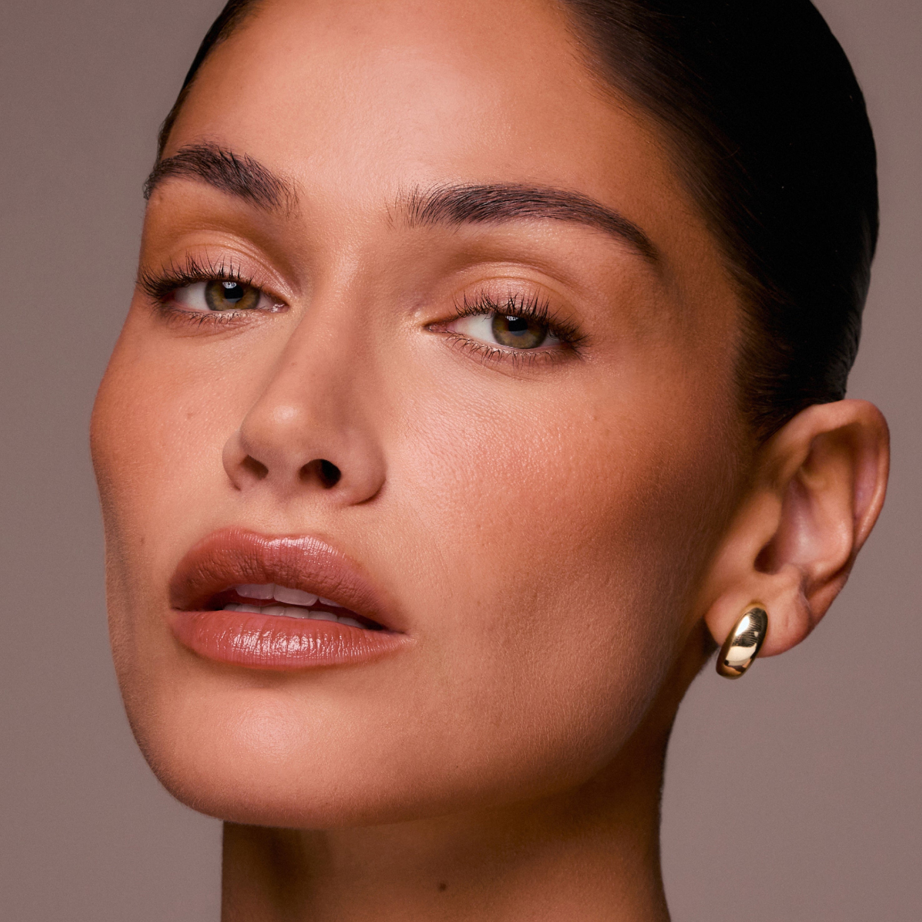 Close-up of a woman's face with a neutral background