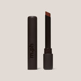 Lipstick with brown shade and 'm.ph' branding on a beige background