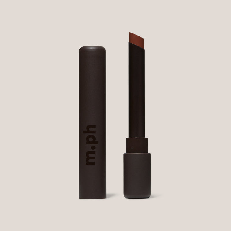 Lipstick with brown shade and 'm.ph' branding on a beige background
