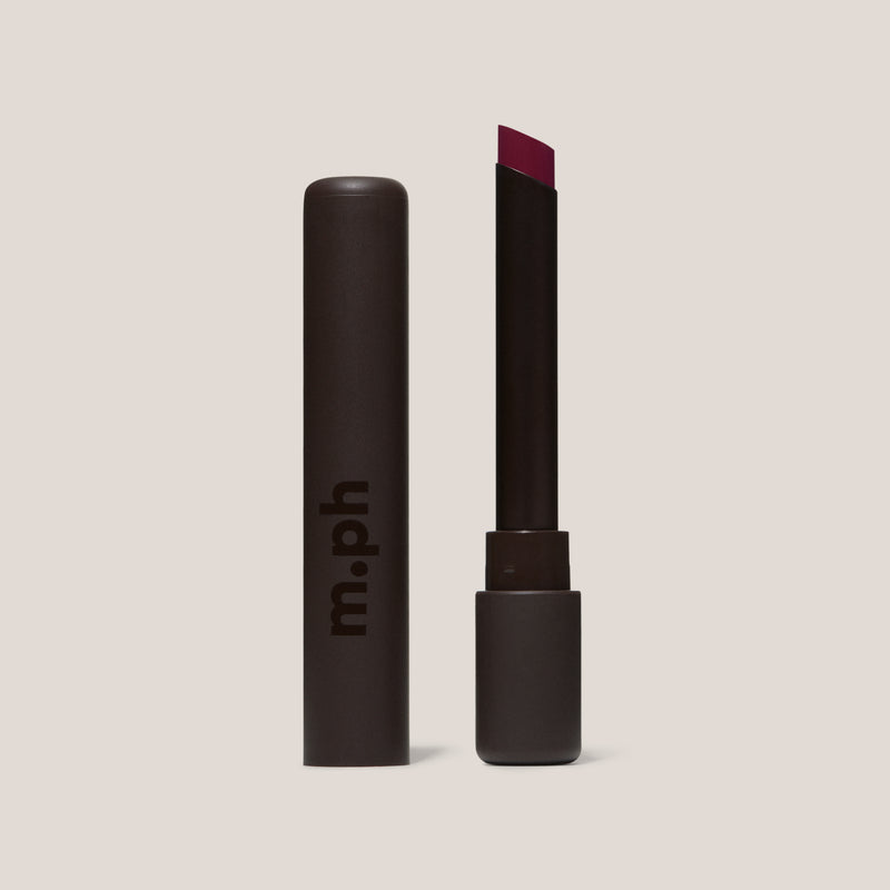 Red lipstick in black package on a white background