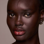 Close-up of a woman's face with a neutral background