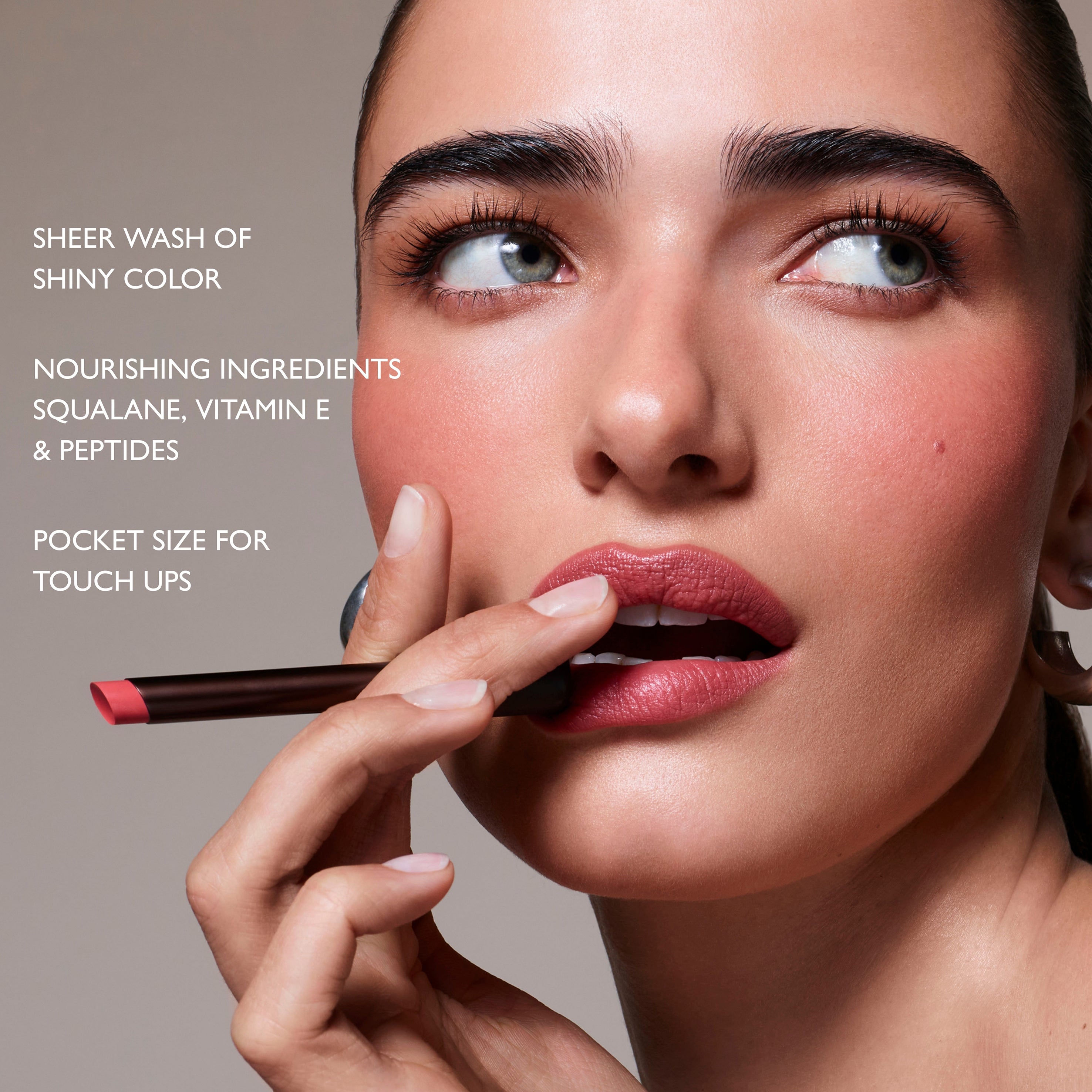 Woman applying lipstick with text about product features on a gray background