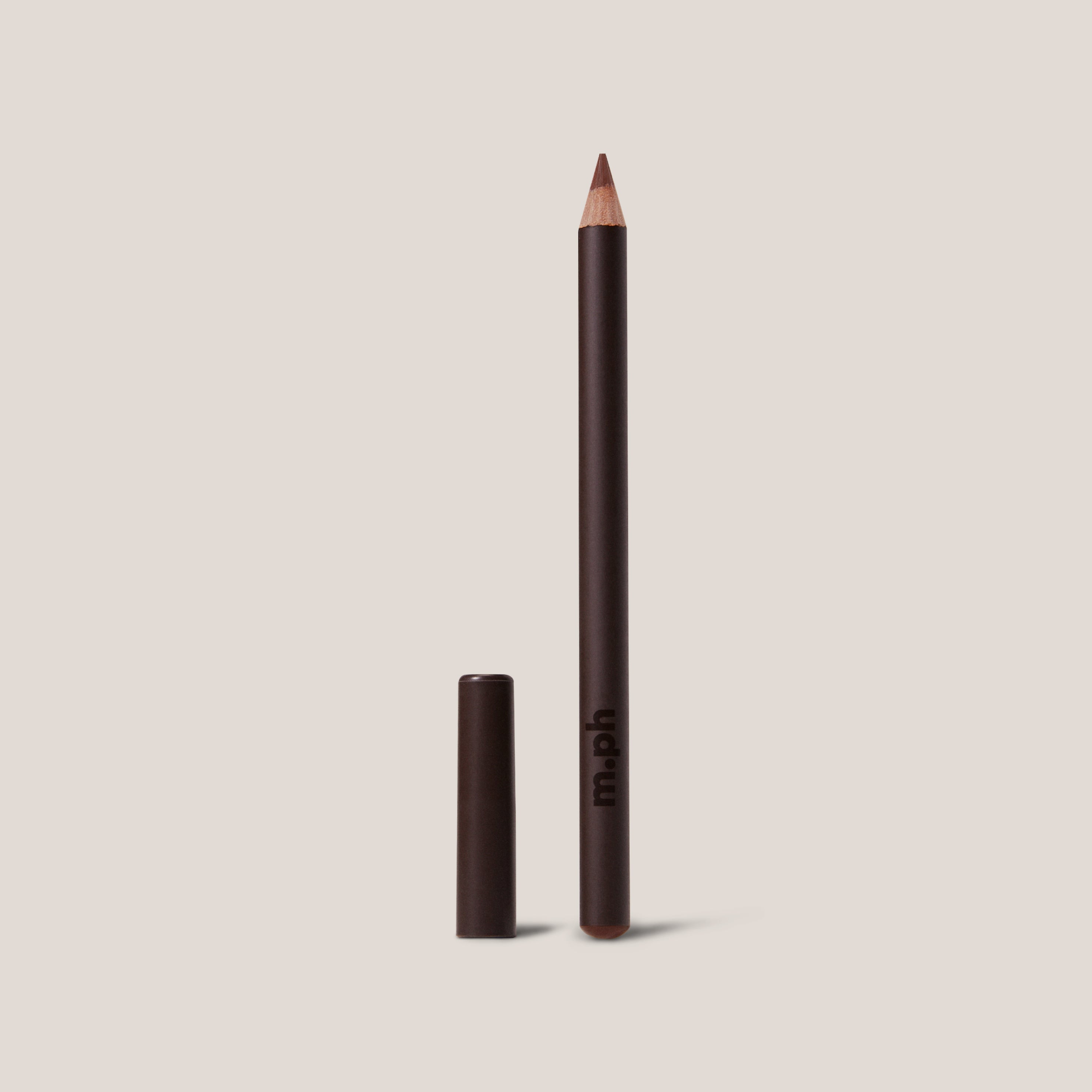Eyeliner pencil with cap on a beige background