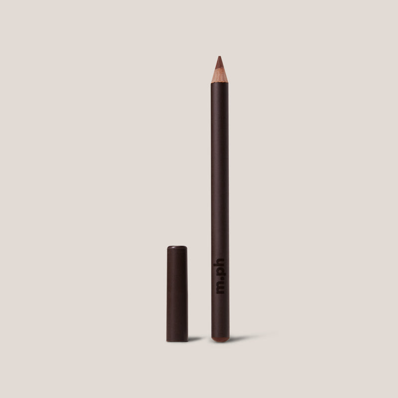 Eyeliner pencil with cap on a beige background