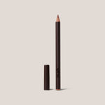 Lip liner pencil with cap on a beige background