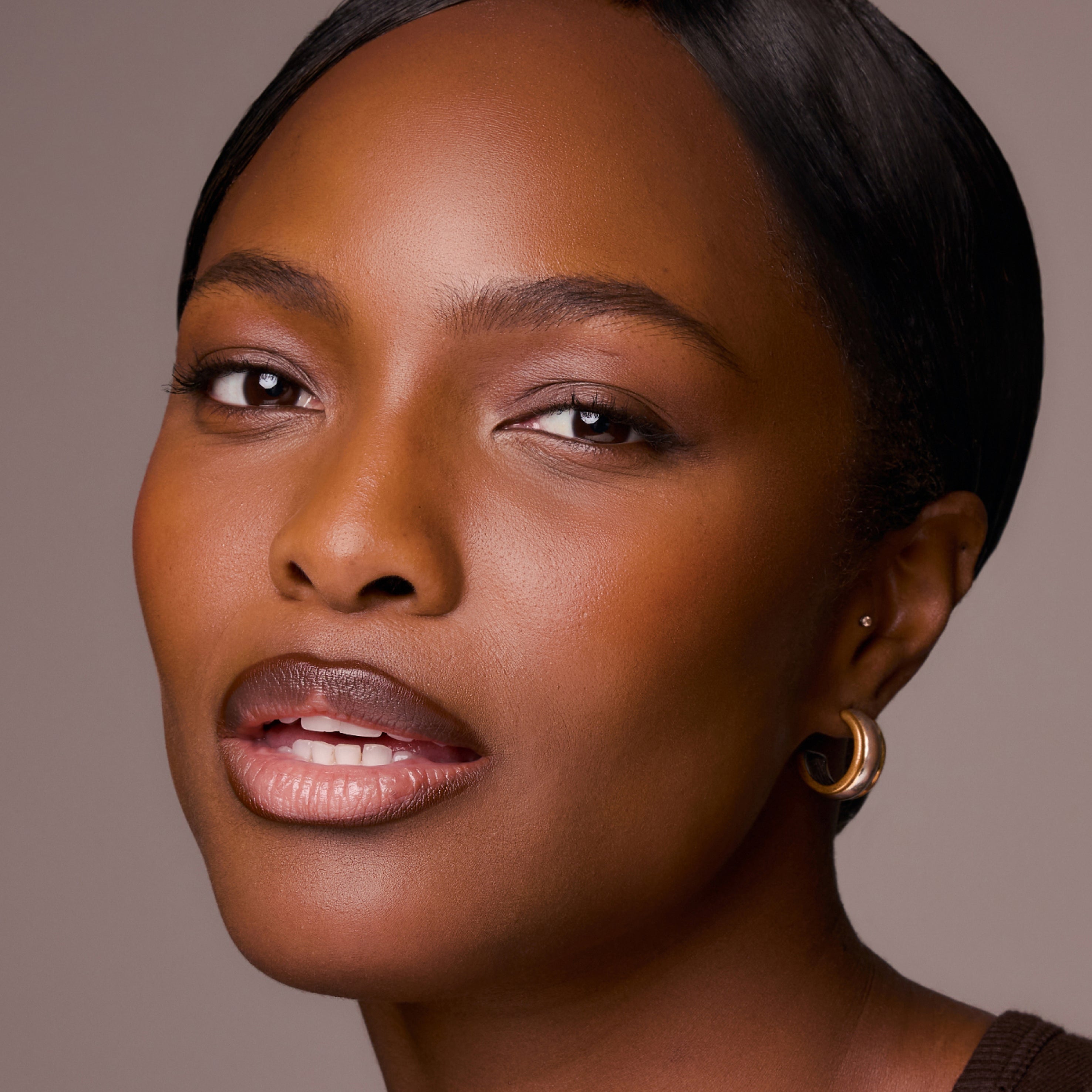 Close-up of a woman with a neutral background