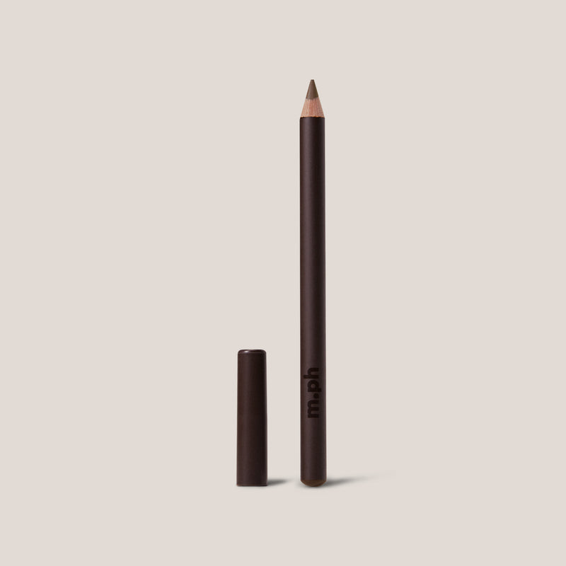 Eyeliner pencil with cap on a beige background