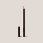 Lip liner pencil with cap on a beige background