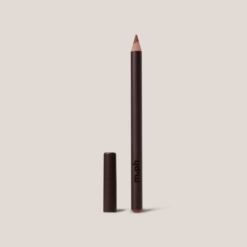 Eyeliner pencil with cap on a beige background