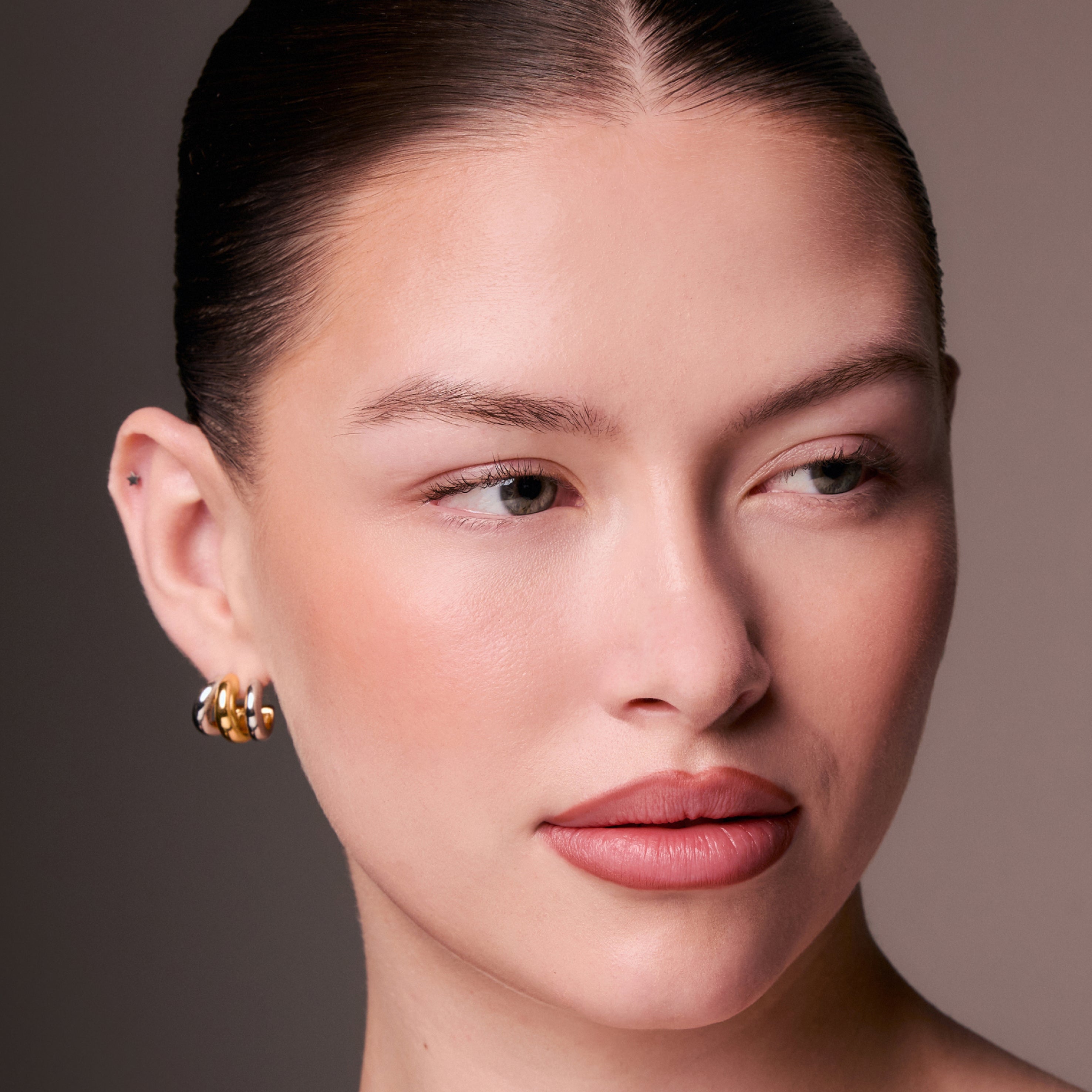 Close-up of a woman's face with a neutral background