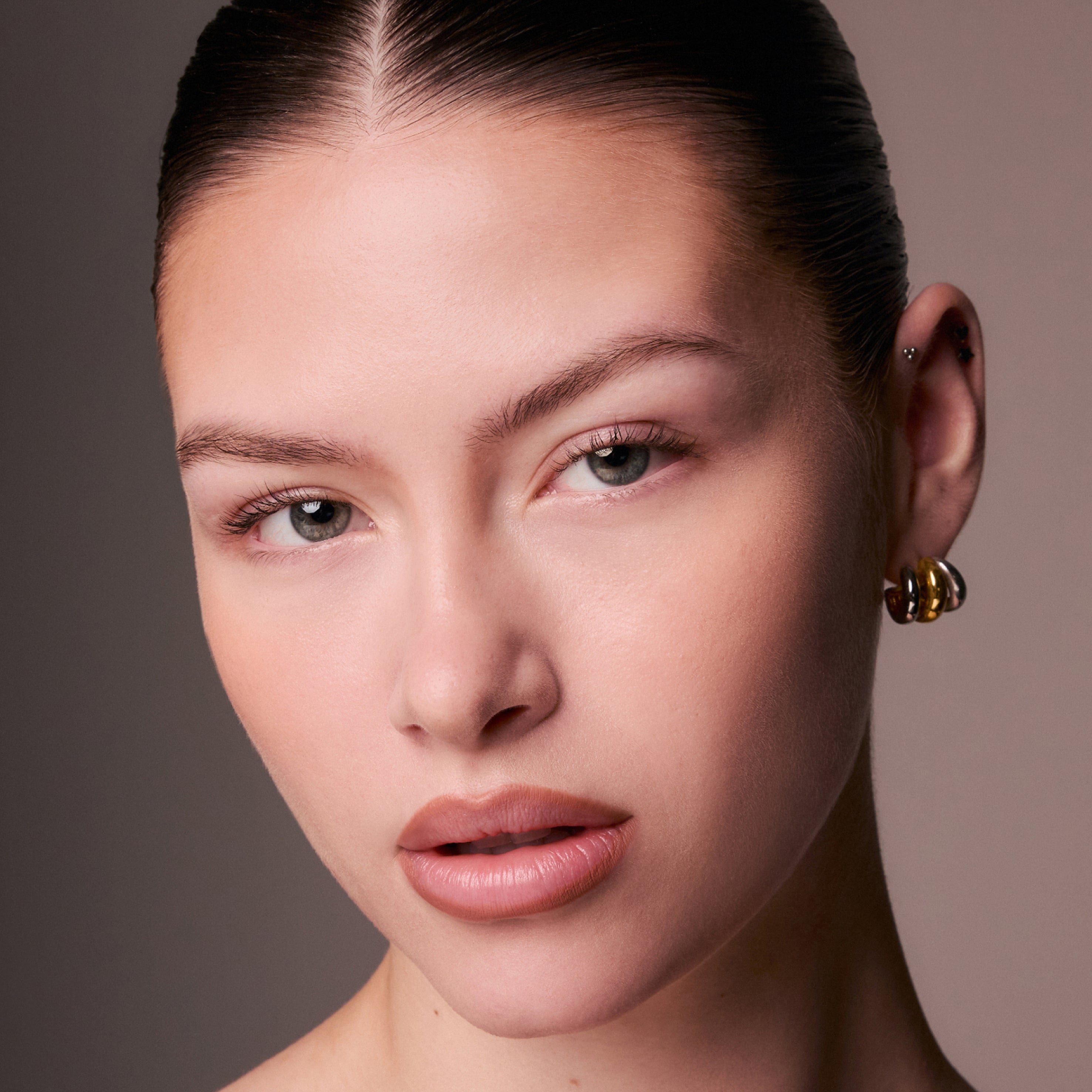 Close-up of a woman's face with a neutral background