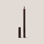 Eyeliner pencil with cap on a beige background