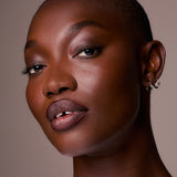 Close-up portrait of a woman with a neutral background