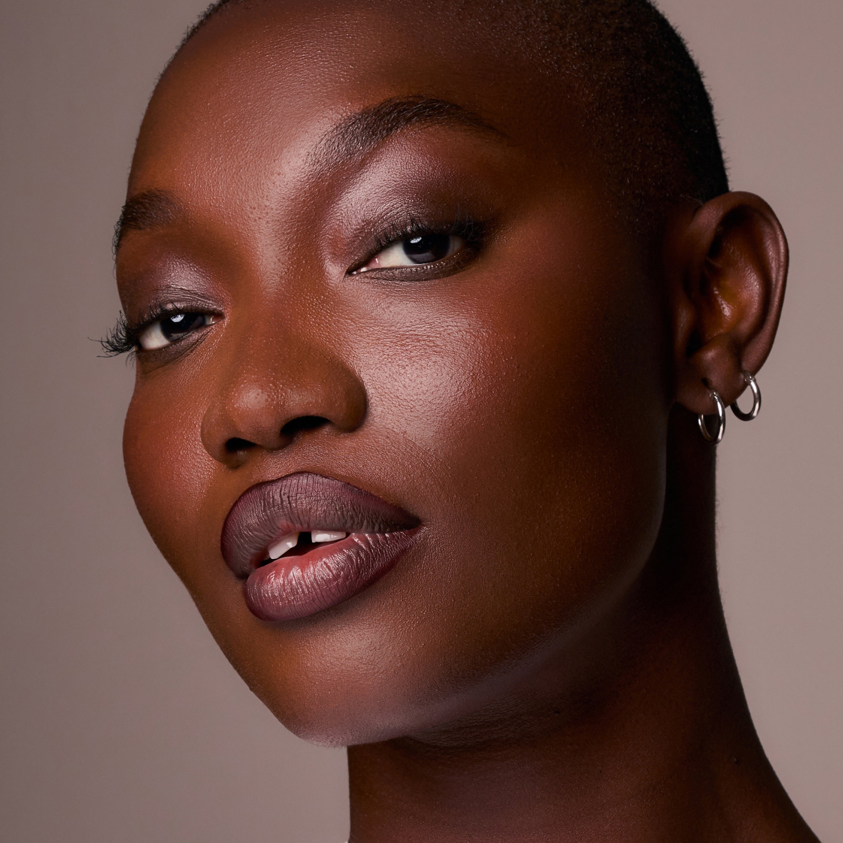 Close-up portrait of a woman with a neutral background