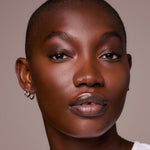 Close-up of deep skin tone with sculpted contour and highlight from the Underpainting palette.