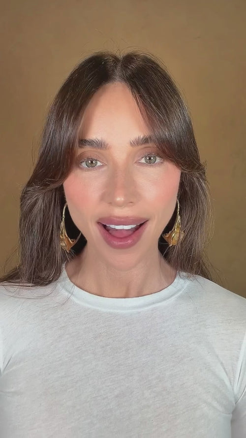 Mary Phillips introduces Top Coat Hydrating Lip Gloss in the color Can't Stop. Mary demonstrates the application and shows the glossy shine. Mary shows the shade range of swatches on her arm